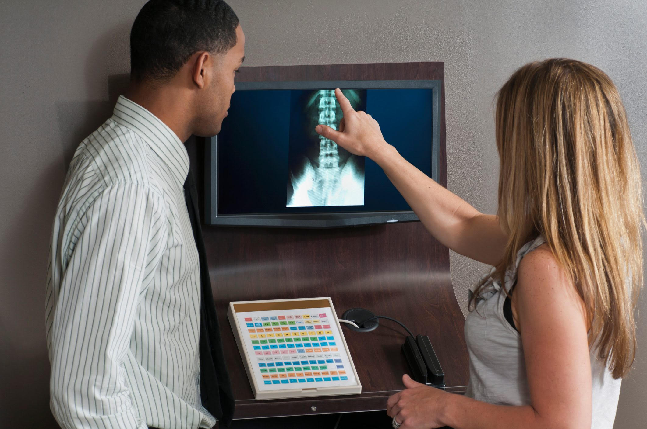 Chiropractor examining spinal X-rays